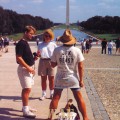 a "JFK is the Beast" protestor at the Washington Mall (with the pond and Washington Monument)