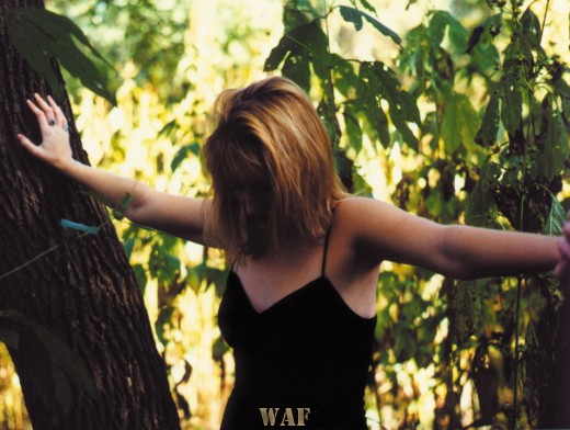 Ariane, with her arms outstretched to trees