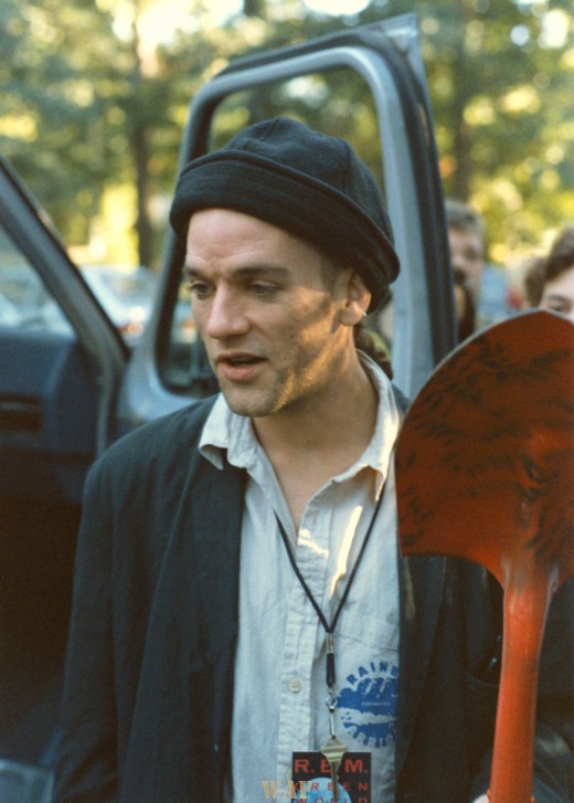 Michael Stipe (of REM) holding a shovel after planting a tree in Urbana, IL